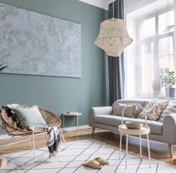 Boho interior design of living room with sofa and rattan armchai